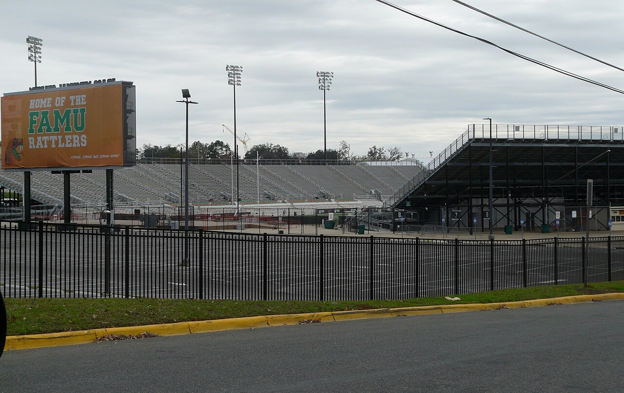 Bragg Memorial Stadium stands and FAMU Rattlers scoreboard behind a black metal fence.