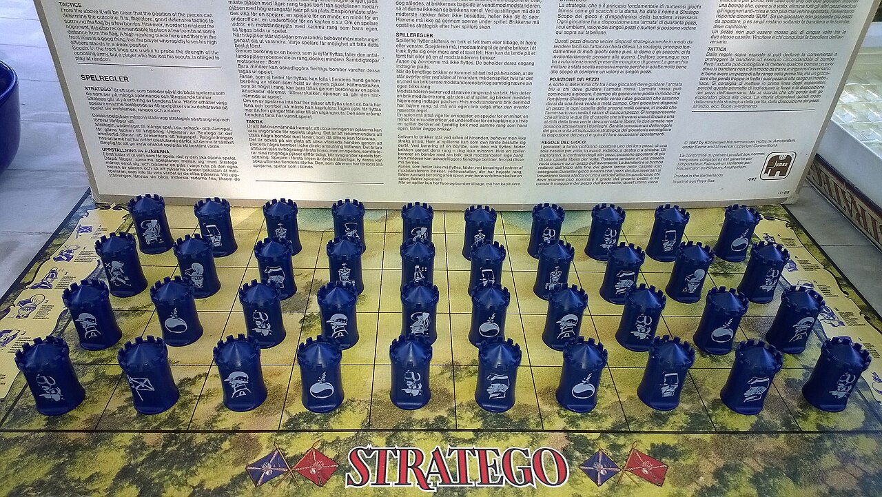 Forty blue Stratego pieces arranged in four rows, with their identifying symbols facing the camera.