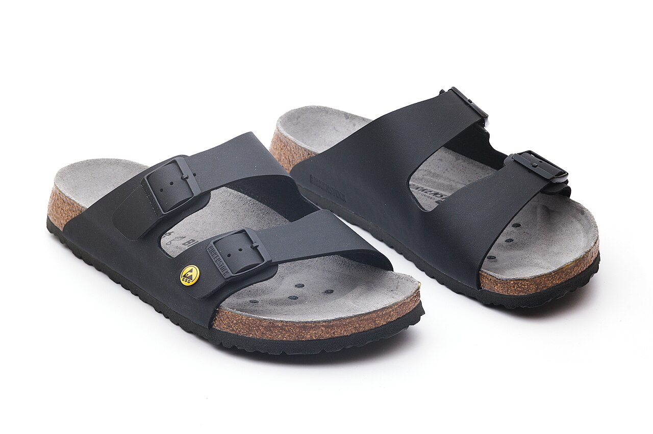 Pair of black Birkenstock Arizona sandals with two buckled straps and cork-edged soles.